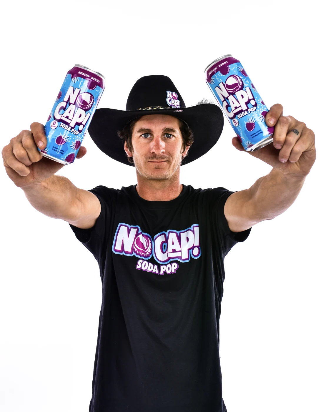 Jarryd holding two NO CAP cans toward the camera